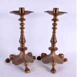 A PAIR OF 19TH CENTURY FRENCH BRONZE CANDLESTICKS of scrolling organic form with paw feet. 30 cm