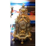 A LARGE ITALIAN SILVERED BRONZE MANTEL CLOCK overlaid with mask heads. 62 cm x 24 cm.
