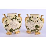 A RARE PAIR OF AESTHETIC MOVEMENT COALPORT TWIN HANDLED PILGRIM FLASKS decorated with foliage in the
