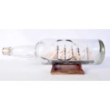 A vintage sailing ship in a bottle 15x43cm.