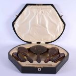 AN ART DECO FAUX TORTOISESHELL DRESSING TABLE SET with silver mounted comb. Box 45cm x 35cm.