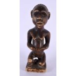 AN AFRICAN TRIBAL CARVED WOOD FIGURE. 21 cm high.