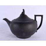 AN ANTIQUE WEDGWOOD BLACK BASALT TEAPOT AND COVER. 22 cm wide.