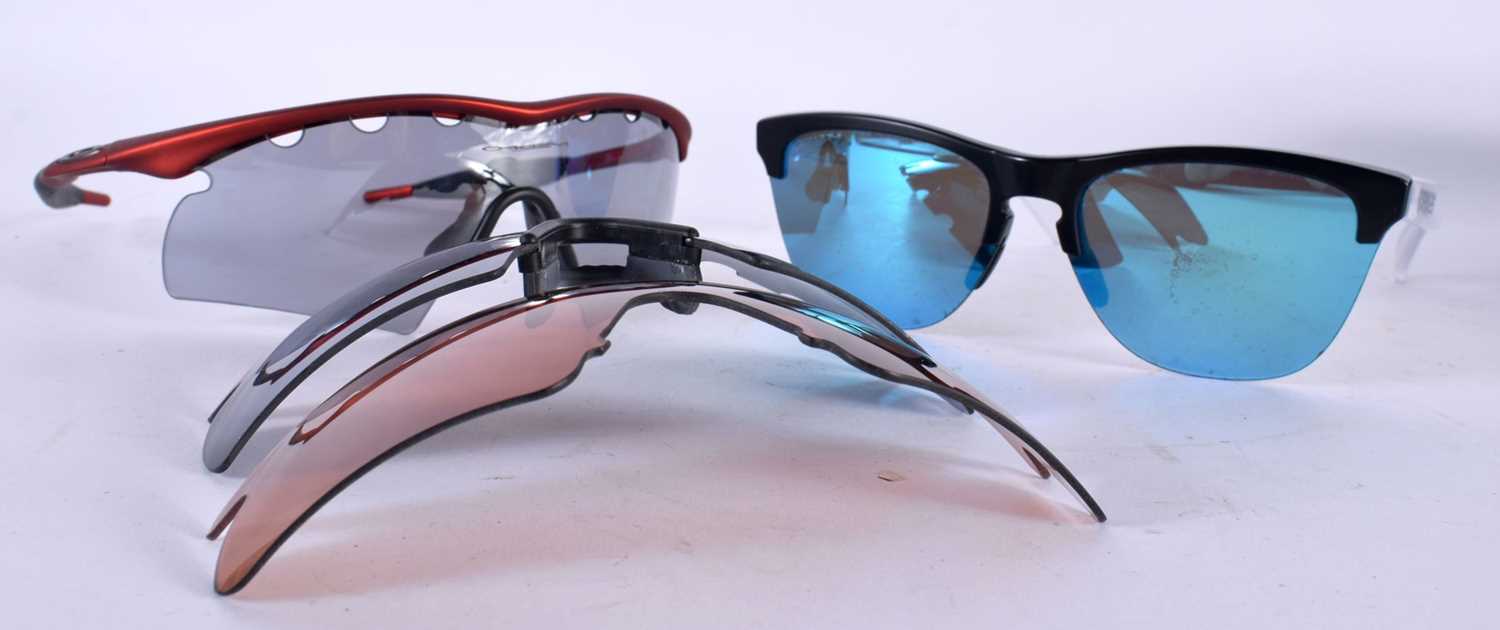 TWO PAIRS OF OAKLEY SUNGLASSES. (2)
