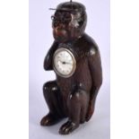 AN UNUSUAL LATE 19TH CENTURY BAVARIAN BLACK FOREST CARVED LINDEN WOOD CLOCK formed as a seated