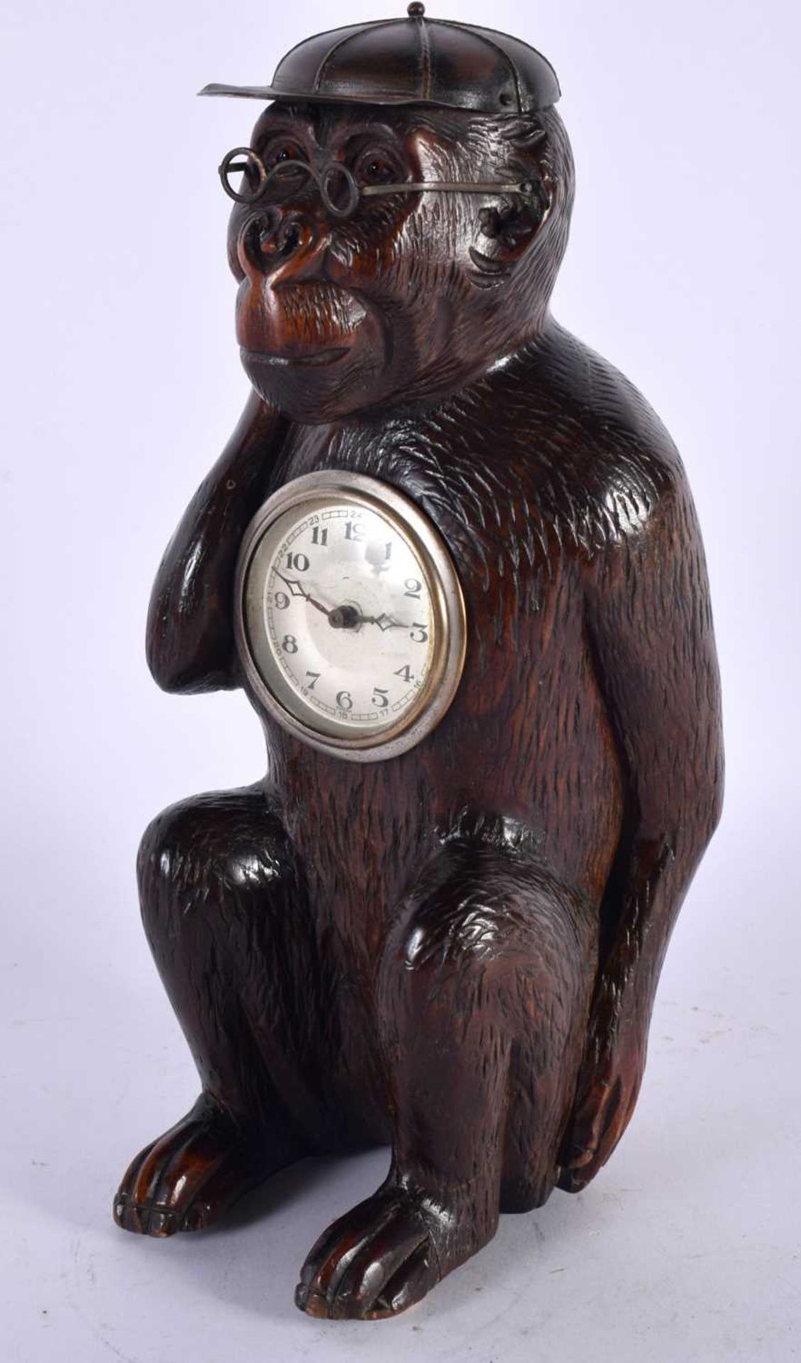 AN UNUSUAL LATE 19TH CENTURY BAVARIAN BLACK FOREST CARVED LINDEN WOOD CLOCK formed as a seated