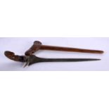 AN UNUSUAL 18TH CENTURY DUTCH CARVED FRUITWOOD CASED KRISS DAGGER with seaweed affect blade, the
