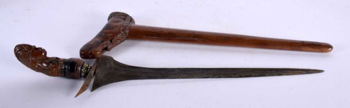 AN UNUSUAL 18TH CENTURY DUTCH CARVED FRUITWOOD CASED KRISS DAGGER with seaweed affect blade, the