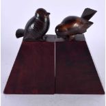 A CHARMING PAIR OF ART DECO CARVED ROSEWOOD AND FRUITWOOD FIGURES OF STYLISED BIRDS modelled upon