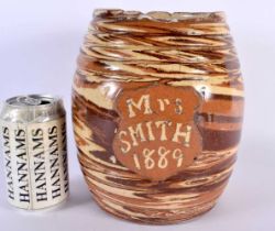 AN UNUSUAL 19TH CENTURY ENGLISH TREACLE GLAZED BISCUIT BARREL entitled Mrs Smith 1889. 21 cm x