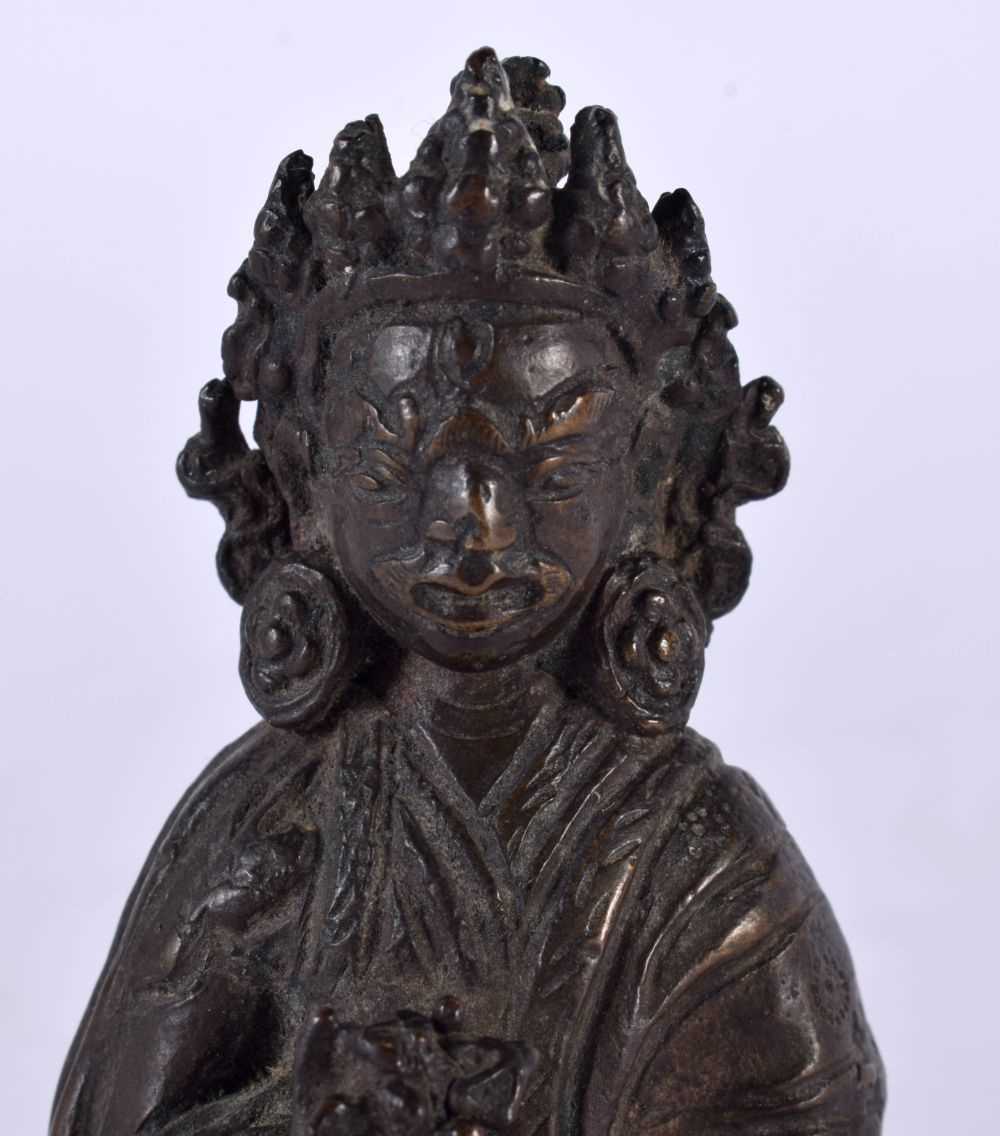 AN 18TH/19TH CENTURY NEPALESE TIBETAN BRONZE FIGURE OF A BUDDHA modelled scowling in robes holding a - Image 2 of 10