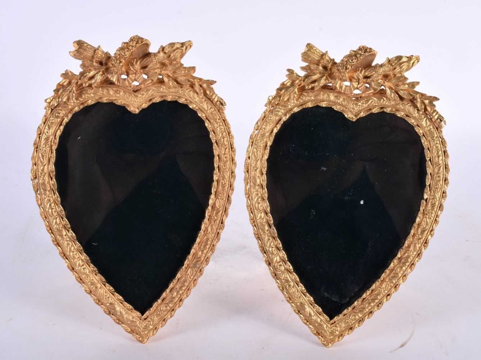 A PAIR OF CONTEMPORARY ORMOLU HEART SHAPED PHOTOGRAPH FRAMES. 18cm x 13 cm.