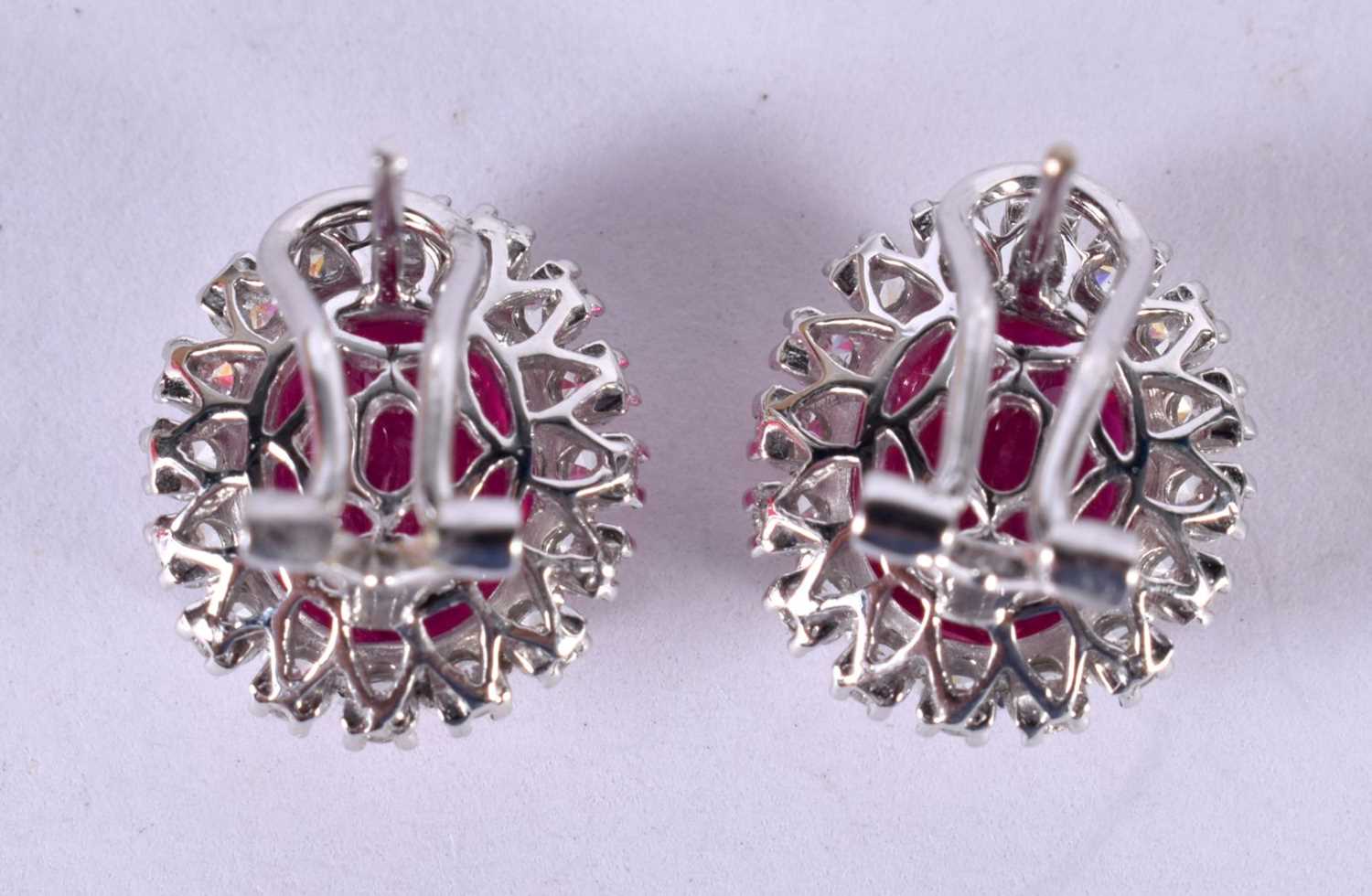 A PAIR OF 14CT WHITE GOLD EARRINGS SET WITH A RUBY SURROUNDED BY A DIAMOND BEZEL. STAMPED 14k 585, - Image 2 of 3
