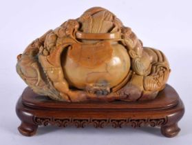 A CHINESE REPUBLICAN PERIOD CARVED SOAPSTONE FIGURAL GROUP depicting buddha's clambering over a