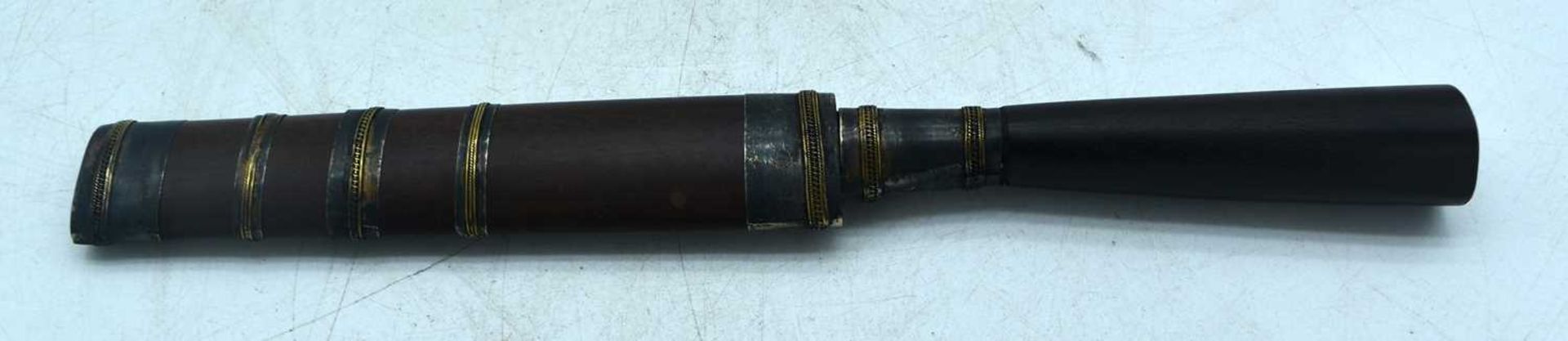 A MIDDLE EASTERN DAGGER WITH A WOOD HANDLE AND SHEATH. BLADE ENGRAVED WITH SCRIPT. Knife 24cm long