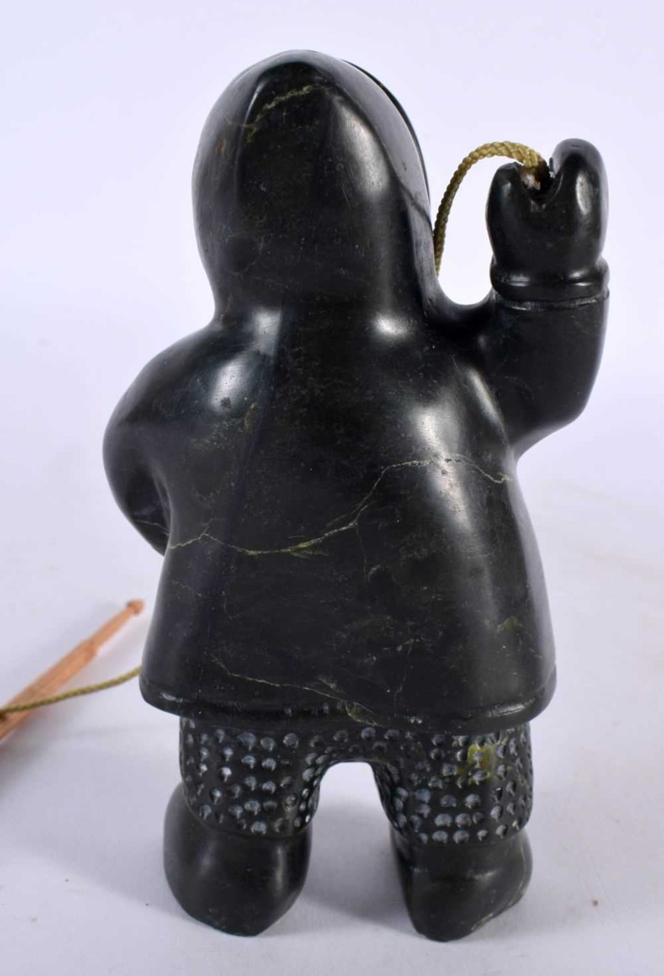 A NORTH AMERICAN CARVED JADE INUIT FIGURE OF AN ESKIMO SEAL HUNTER modelled holding a spear and - Image 4 of 6