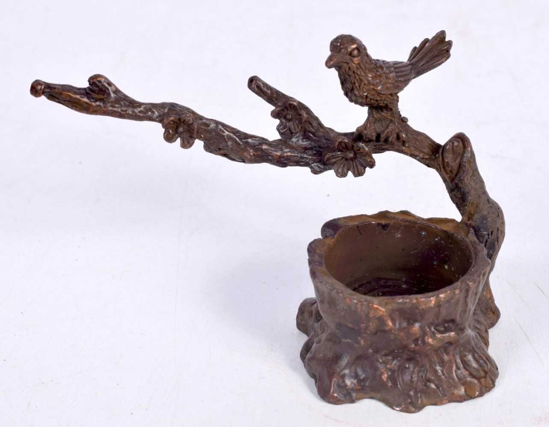 A BRONZE MODEL OF A BIRD ON A BRANCH. 9.8 cm x 6.3cm x 5.6 cm, weight 135g