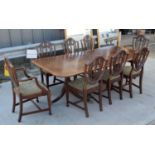 A Mahogany dining table with a veneer edging with 8 mahogany Shield back chairs with upholstered