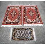 A pair of small Boukhara rugs together with a prayer mat largest 108 x 60 cm. (3).