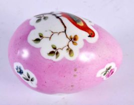 A 19TH CENTURY CONTINENTAL PORCELAIN PINK GROUND EGG painted with birds perched amongst