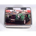 A SILVER PILL BOX WITH TOP DECORATION OF A VINTAGE RACE CAR. Stamped Sterling, 2.6 cm x 1.3cm x 3.