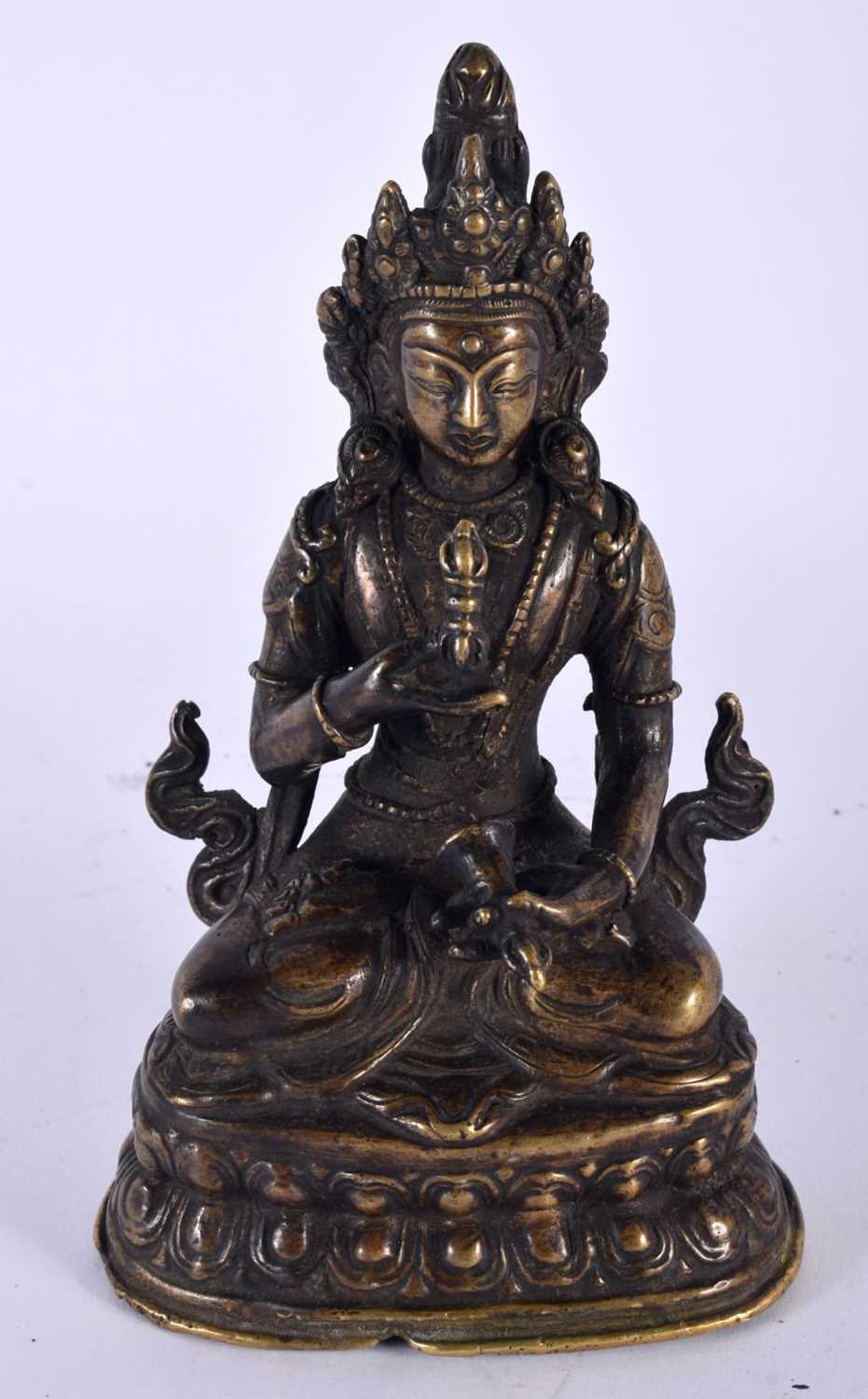 A 19TH CENTURY TIBETAN NEPALESE BRONZE FIGURE OF A SEATED BUDDHA modelled upon a triangular lotus