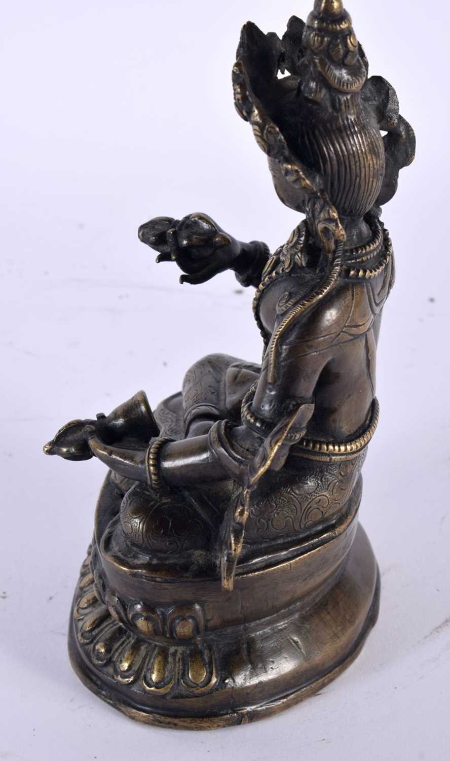 A 19TH CENTURY TIBETAN NEPALESE BRONZE FIGURE OF A SEATED BUDDHA modelled holding buddhistic - Image 2 of 4