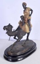 A large cold painted bronze Arab riding a camel set on a marble plinth 40 cm .