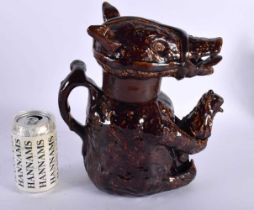 A LARGE 19TH CENTURY ENGLISH NOTTINGHAMSHIRE POTTERY BEAR BAITING JUG AND COVER modelled clutching a