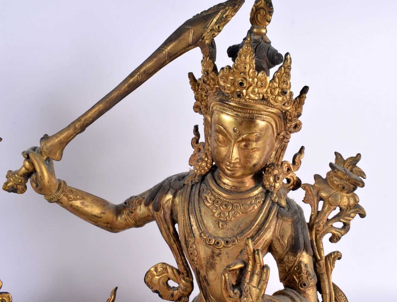 A LARGE PAIR OF 19TH CENTURY CHINESE TIBETAN GILT BRONZE FIGURES OF BUDDHAS Qing, modelled upon - Image 3 of 9