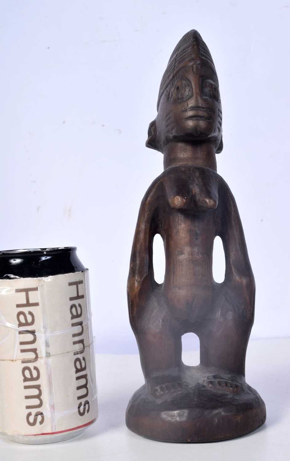 A carved wood Nigerian Yoruba female Ibeji figure 24 cm.
