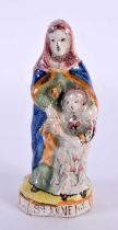 AN ANTIQUE FRENCH FAIENCE TIN GLAZED POTTERY FIGURE OF ST ANNE. 9.5 cm high.