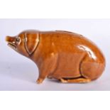 A SMALL TREACLE GLAZED PIG POTTERY MONEY BOX. 13 cm x 8 cm.
