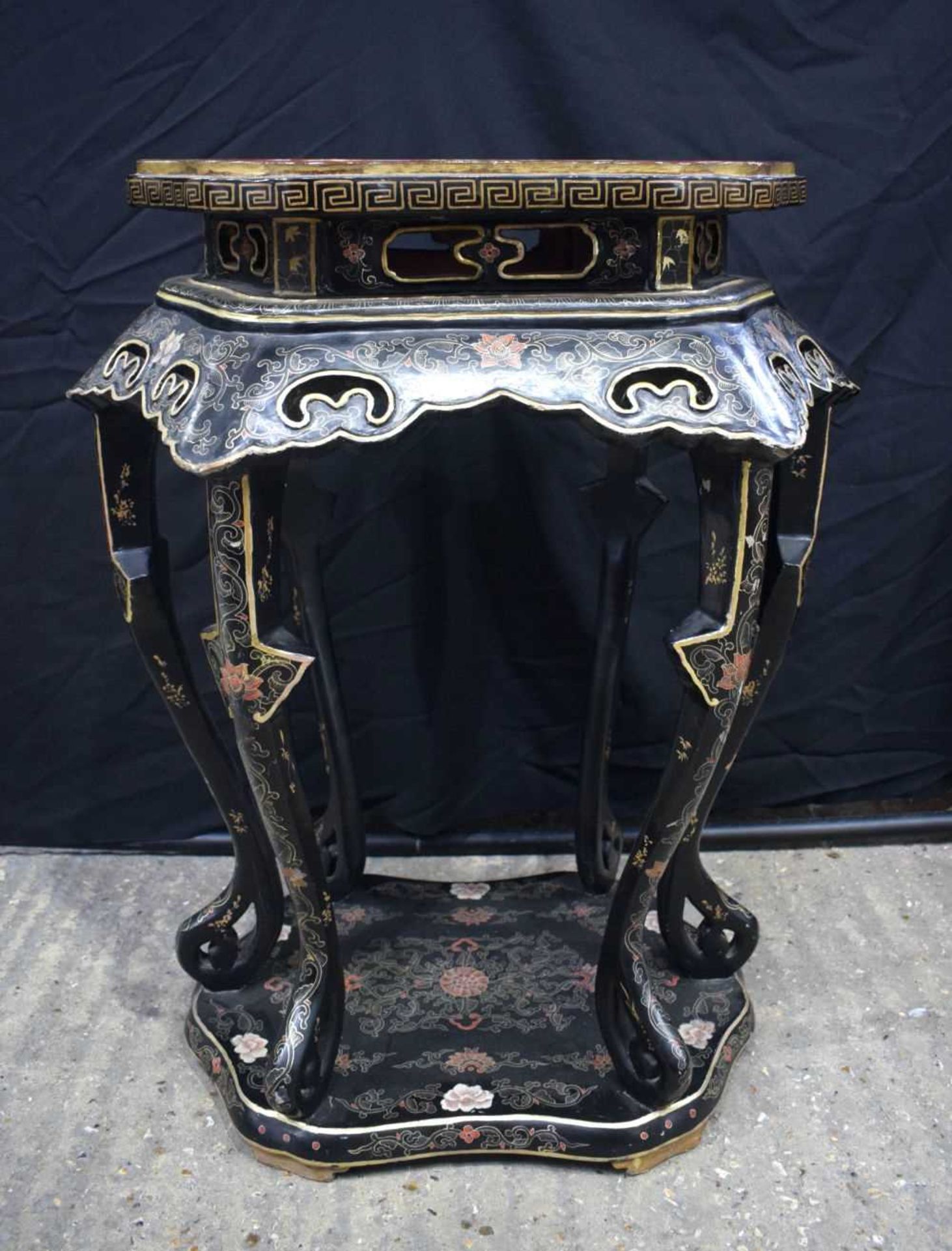A 19th Century Chinese laquered table decorated with gilt decoration of a lakeside scene 93 x 77 x