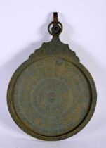 A 19TH CENTURY ISLAMIC MIDDLE EASTERN BRONZE ASTROLABE decorated with calligraphy and scripture.