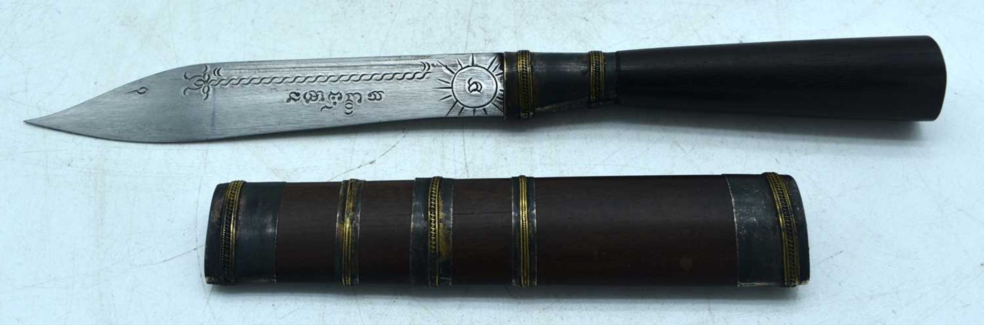 A MIDDLE EASTERN DAGGER WITH A WOOD HANDLE AND SHEATH. BLADE ENGRAVED WITH SCRIPT. Knife 24cm long - Image 2 of 3