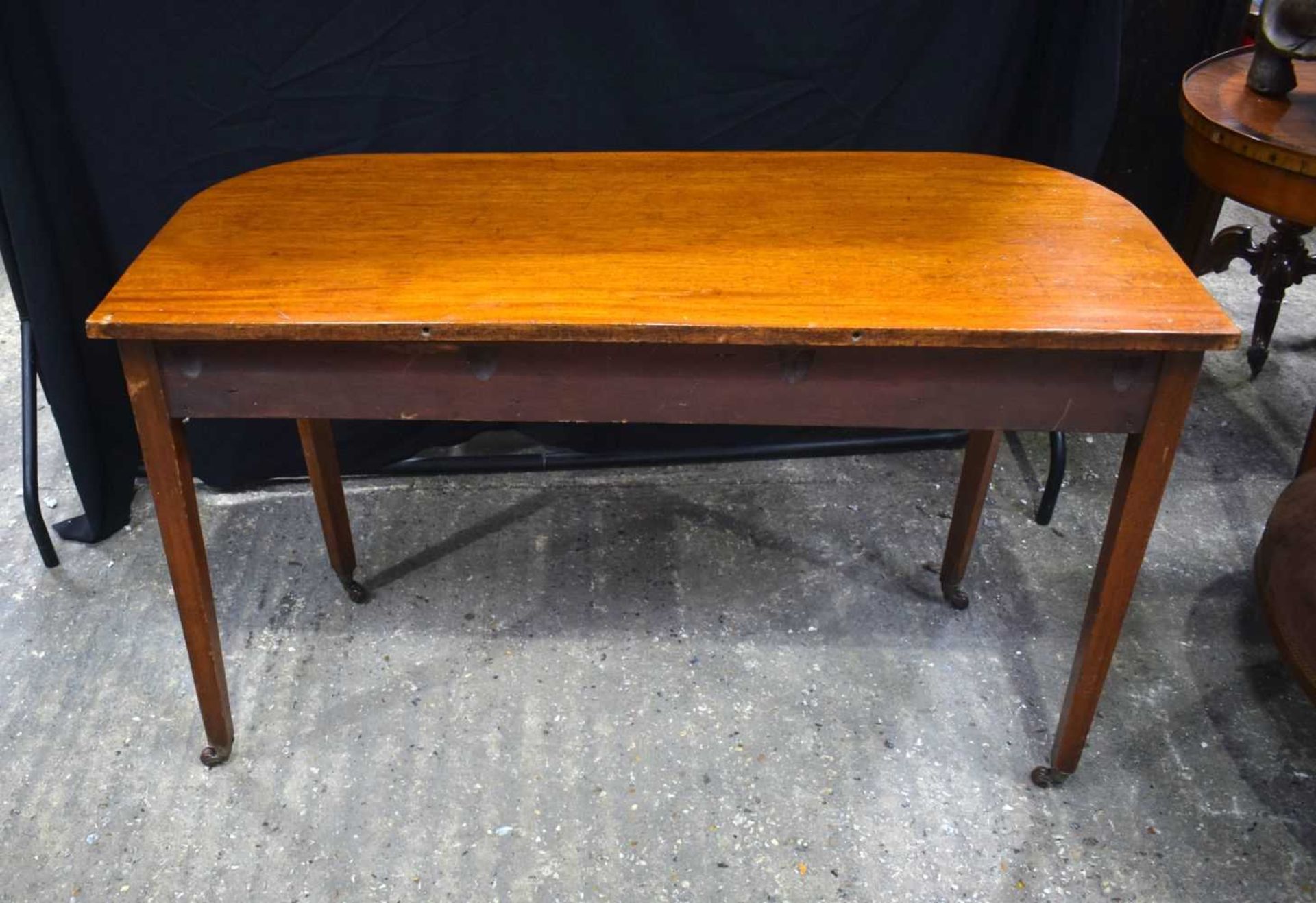 A 19th Century Bow fronted mahogany top side table with castored legs 75 x 124 x 53 cm. - Image 4 of 4