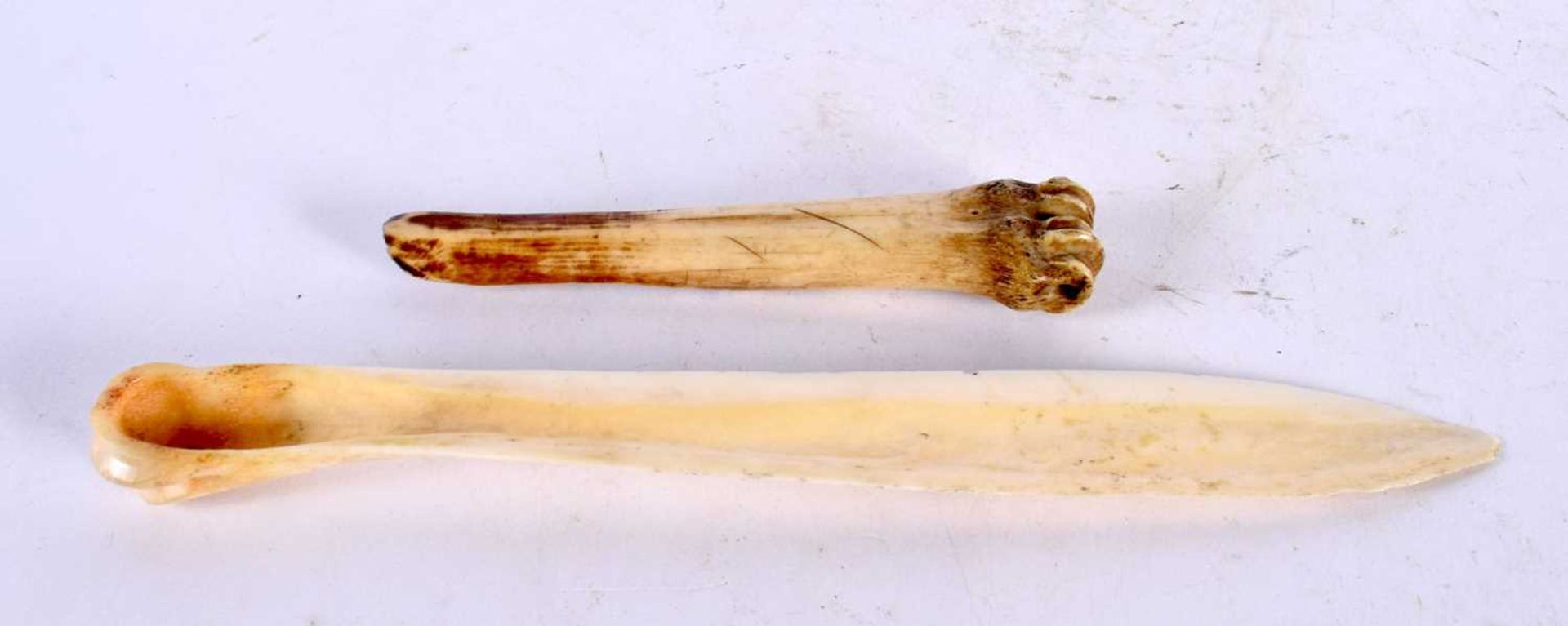 AN ANTIQUE CARVED BONE TRIBAL MARROW SCOOP together with a carved scrimshaw letter opener. 52 grams. - Image 2 of 2