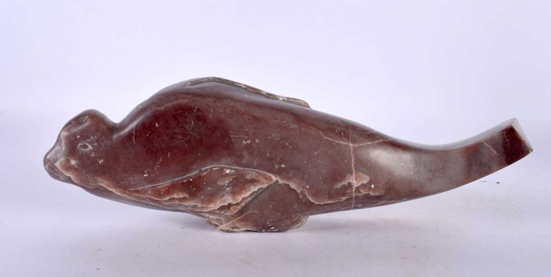 A LARGE EARLY 20TH CENTURY NORTH AMERICAN INUIT CARVED STONE SEAL of unusual form. 27 cm wide.