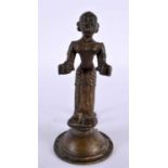AN UNUSUAL 18TH CENTURY INDIAN BRONZE FIGURE OF A STANDING DEITY modelled holding two open cups.