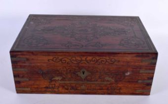 AN ANGLO INDIAN ROSEWOOD BRASS INLAID JEWELLERY BOX decorated with foliage and vines. 30cm x 20cm.