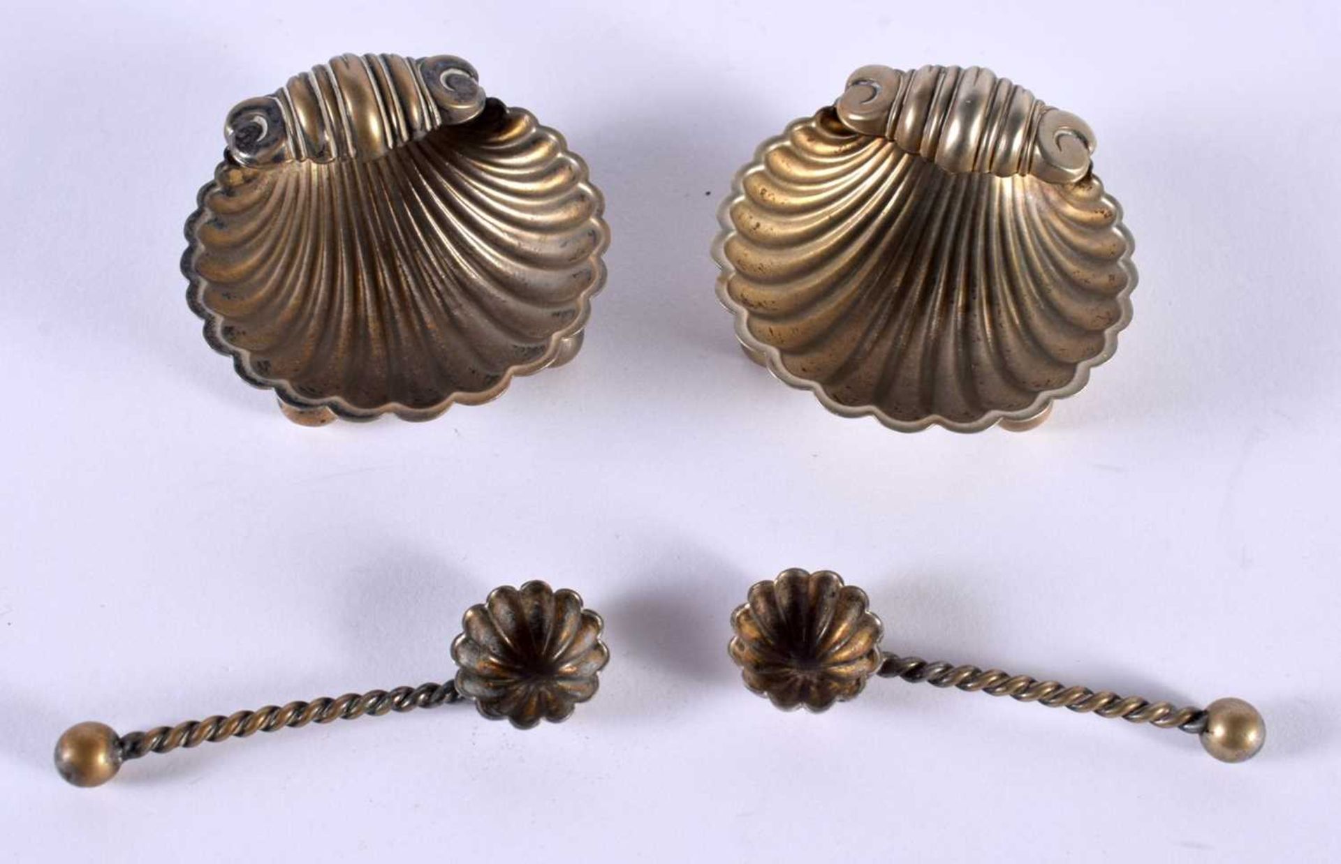 A PAIR OF ANTIQUE SILVER PLATED SHELL SALTS. 42 grams. Largest 5 cm x 4.5 cm. (4)