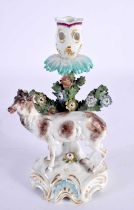 AN 18TH CENTURY ENGLISH PORCELAIN CANDLESTICK formed as a standing deer, behind an encrusted