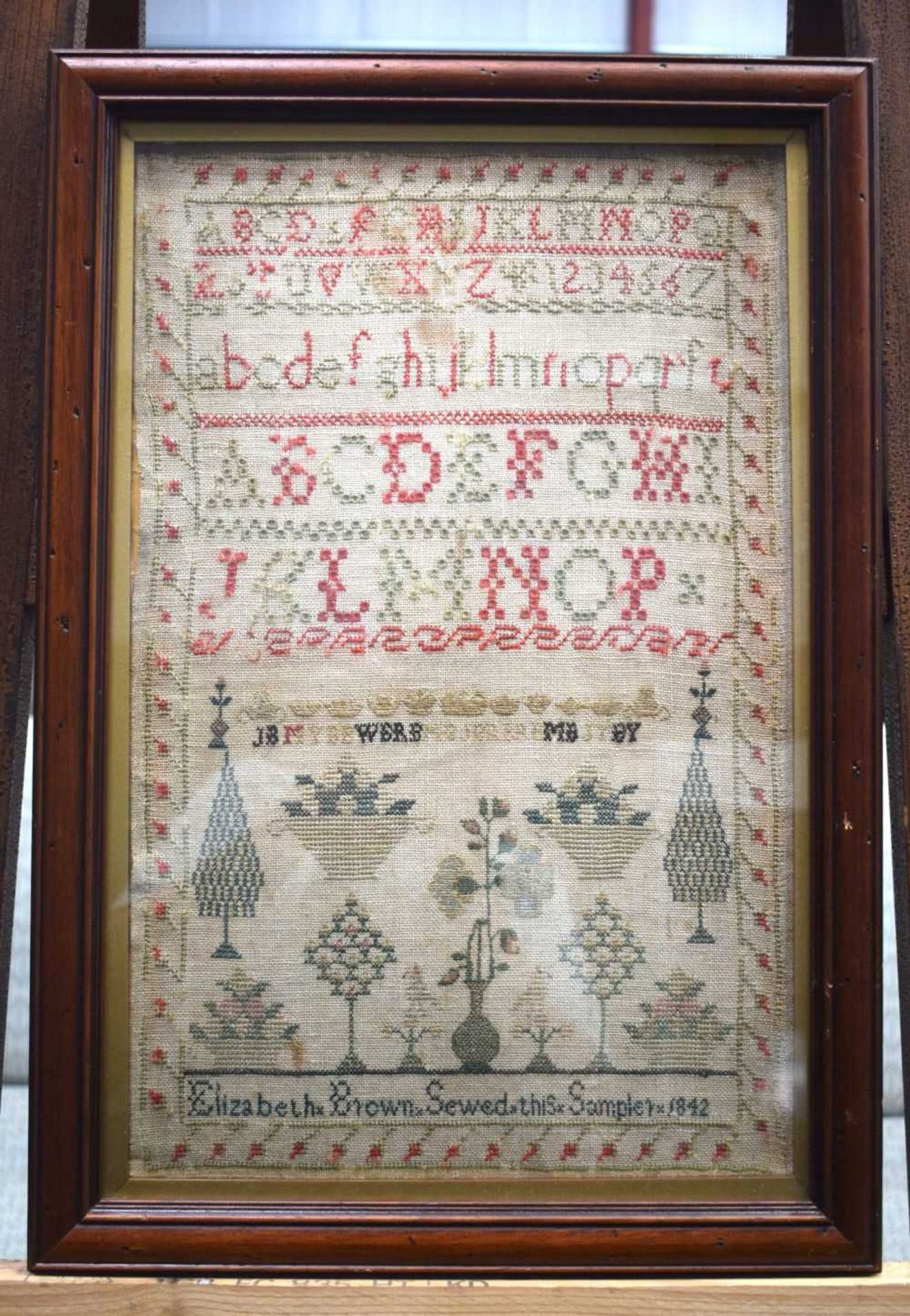 A framed Sampler dated 1842 45 x 28cm.