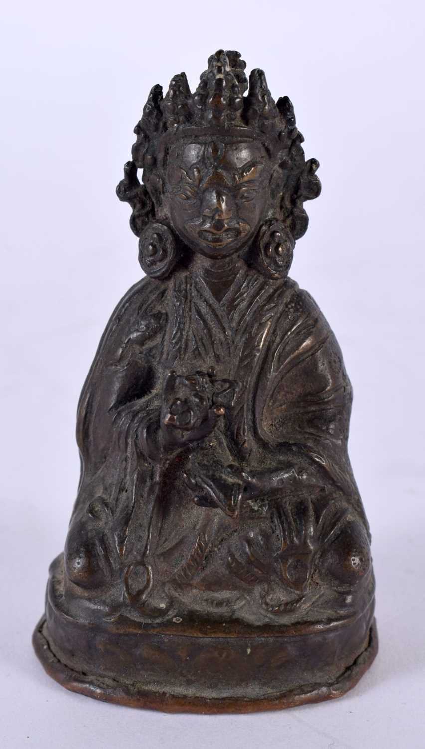 AN 18TH/19TH CENTURY NEPALESE TIBETAN BRONZE FIGURE OF A BUDDHA modelled scowling in robes holding a