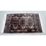 An Oriental rug 128 x 75 cm.