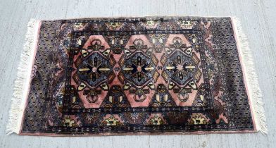 An Oriental rug 128 x 75 cm.