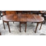 A Mahogany Dining table comprising of a central drop leaf table and two Demilune shaped extensions
