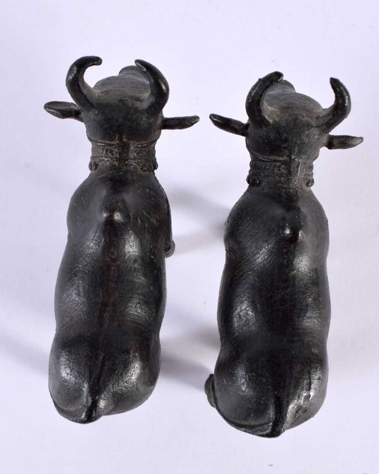 A PAIR OF 18TH/19TH CENTURY INDIAN BRONZE FIGURES OF NANDI BULLS modelled roaming. 11cm x 8 cm. - Image 4 of 5