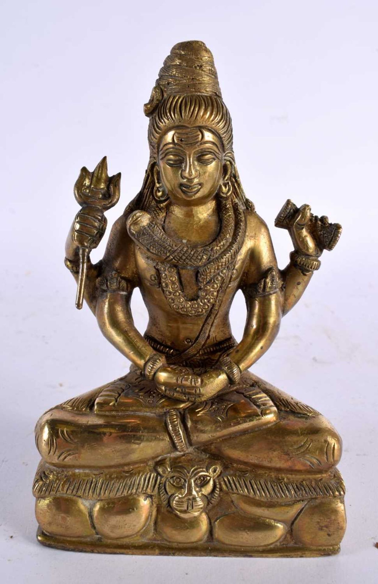 A 19TH CENTURY INDIAN BRONZE HINDU FIGURE OF SHIVA modelled seated on a lion skin with vasuki,